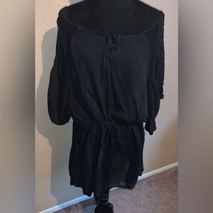 Black swim cover up with lace detail.